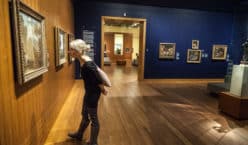 Montreal, Canada - Montreal Fine Arts Museum Room with Paintings on the wall and Young Adult looking at it.