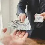 Businessman giving money, US dollar bills - loan,payment, bribery and corruption concepts for $30 an hour